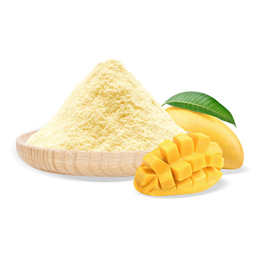 Mango powder in a wooden bowl with fresh mango pieces and a leaf on a white background