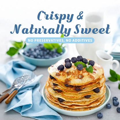 Stack of pancakes with blueberries on a plate, surrounded by blue napkins and a bowl of blueberries, with text about the product.
