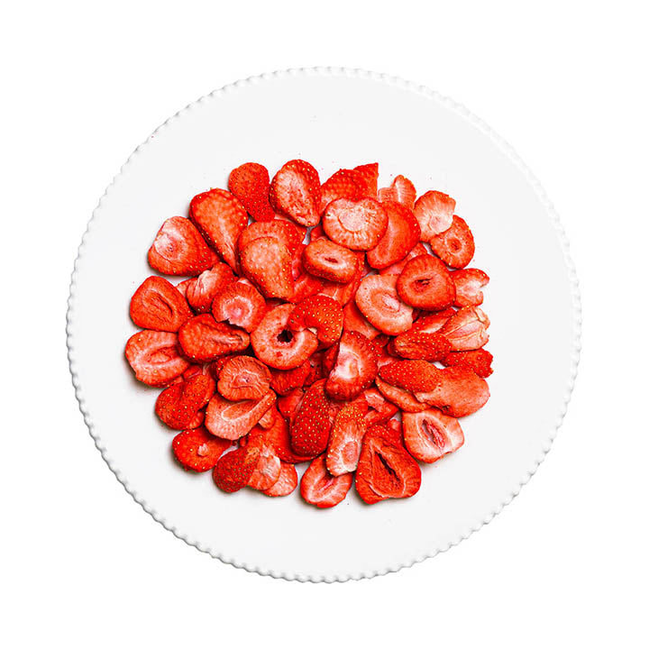 Sliced strawberries on a white plate with a white background