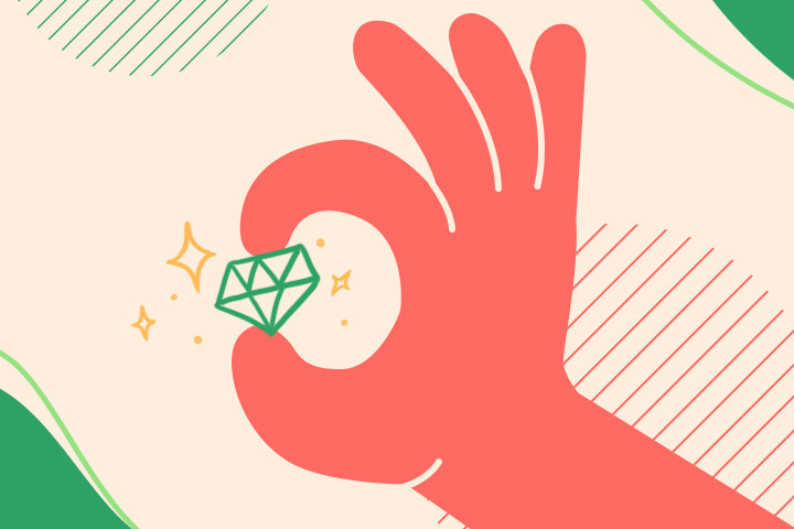 Red hand holding a green diamond against a beige background with geometric shapes